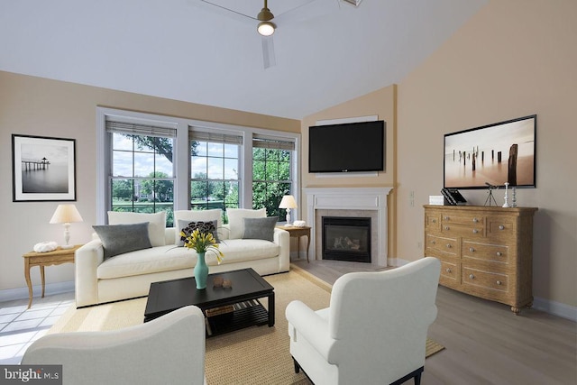 living room with wood-type flooring, ceiling fan, and lofted ceiling