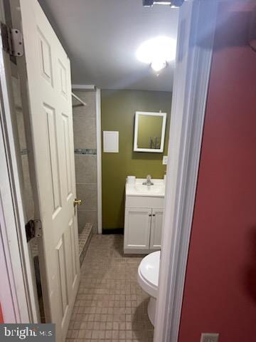 bathroom featuring vanity, toilet, and walk in shower