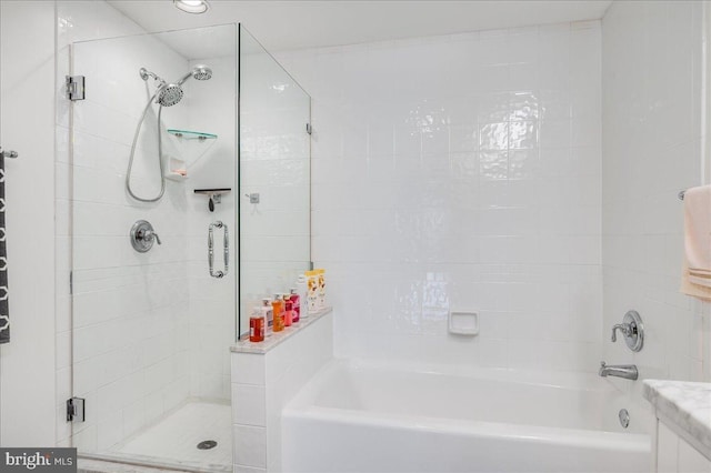 bathroom featuring plus walk in shower and vanity