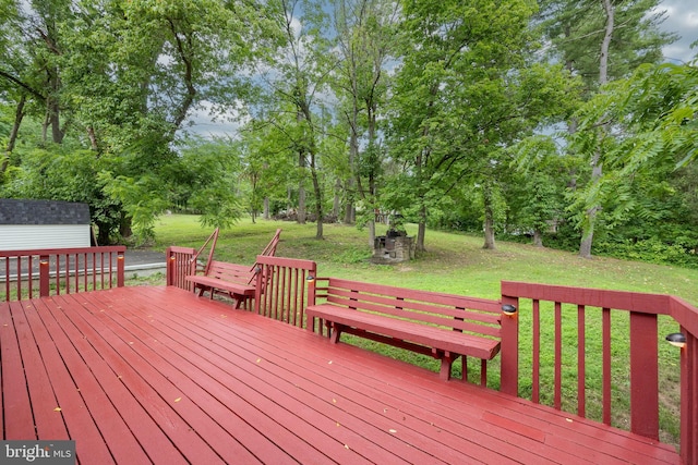 wooden terrace with a lawn