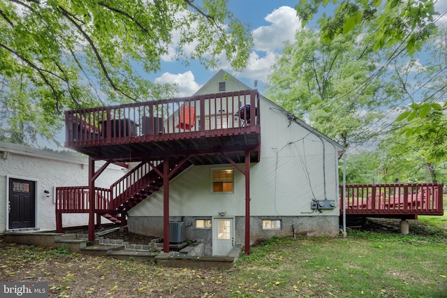 rear view of house with central AC, a yard, and a deck