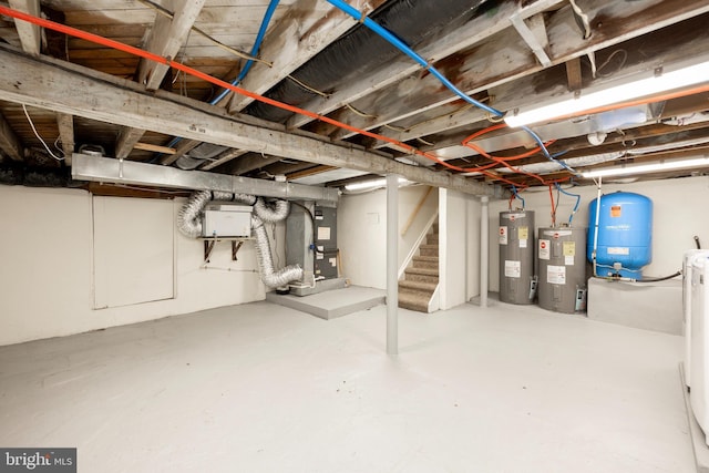 basement featuring heating unit and water heater