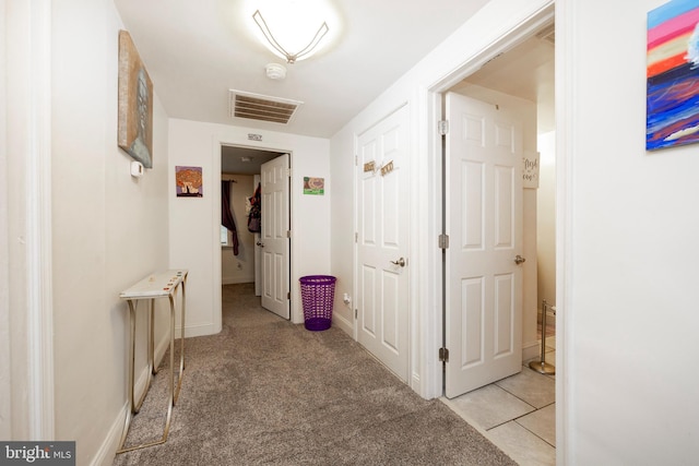 hall with light colored carpet