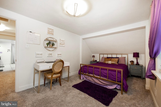 carpeted bedroom with vaulted ceiling