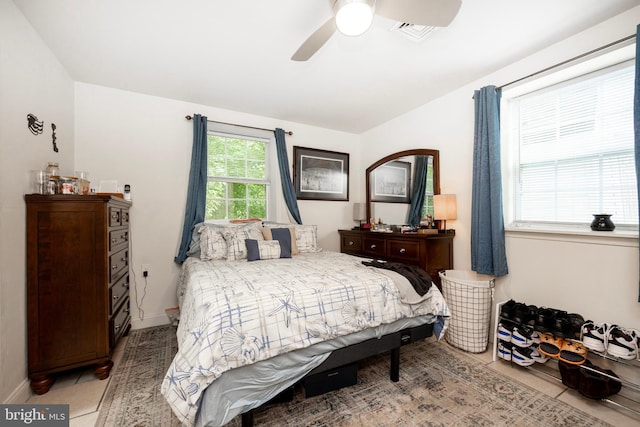 tiled bedroom with ceiling fan