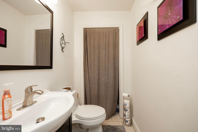 bathroom with tile patterned flooring, toilet, and sink