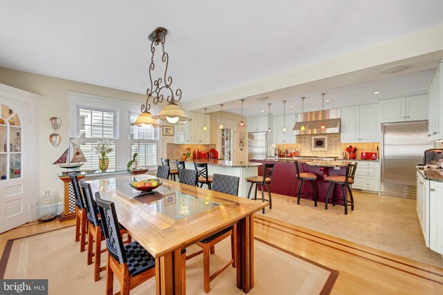 dining area featuring an inviting chandelier and light hardwood / wood-style flooring