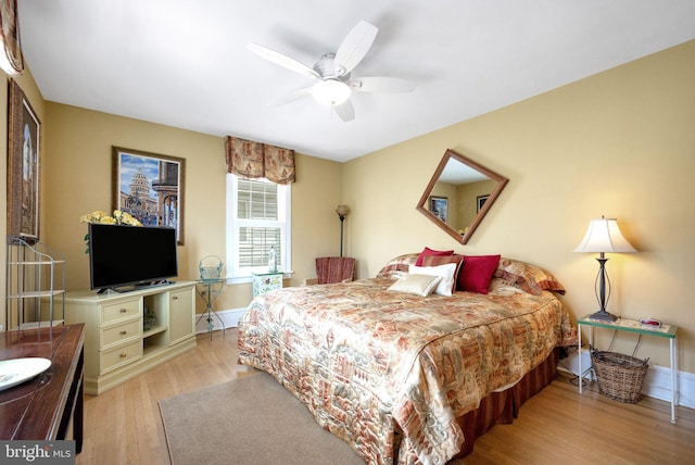 bedroom with ceiling fan and light hardwood / wood-style flooring