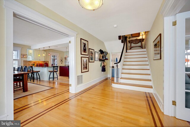 living room featuring a brick fireplace, french doors, and hardwood / wood-style floors