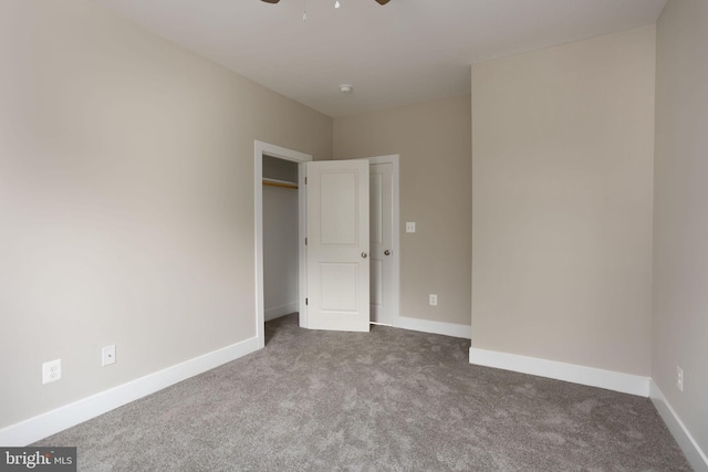 unfurnished bedroom featuring ceiling fan and carpet