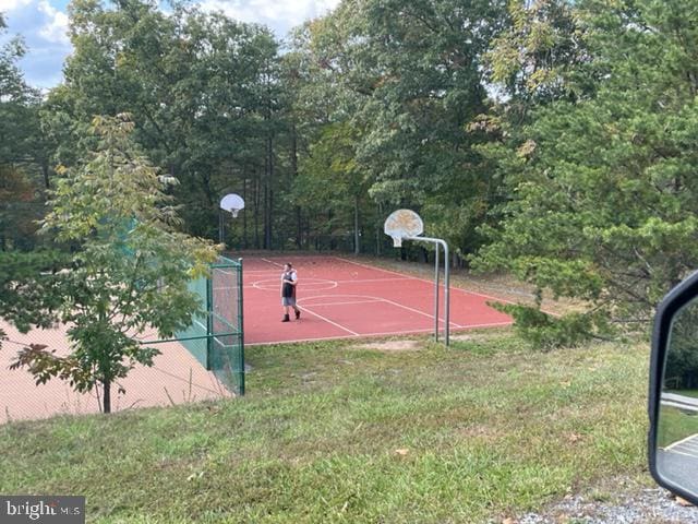 view of basketball court featuring a yard