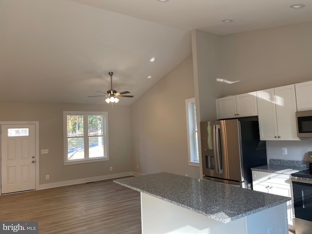 kitchen featuring stone counters, light hardwood / wood-style flooring, high vaulted ceiling, white cabinets, and appliances with stainless steel finishes