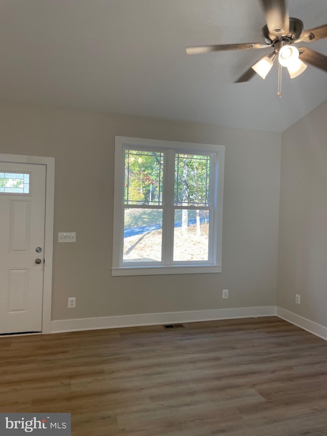 foyer entrance featuring lofted ceiling, ceiling fan, and dark hardwood / wood-style flooring