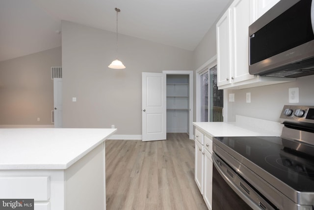 kitchen featuring appliances with stainless steel finishes, pendant lighting, white cabinetry, and vaulted ceiling