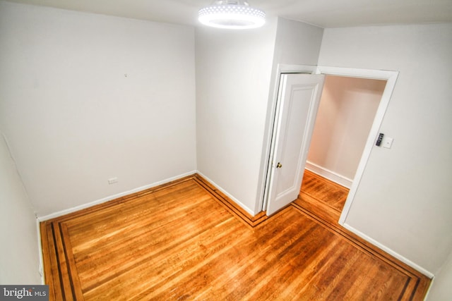 spare room with hardwood / wood-style flooring