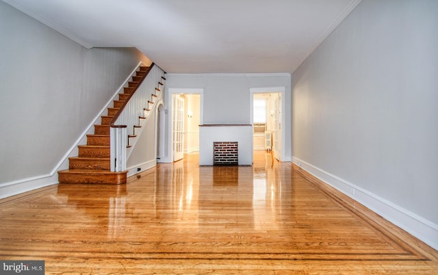 interior space with light hardwood / wood-style flooring and ornamental molding