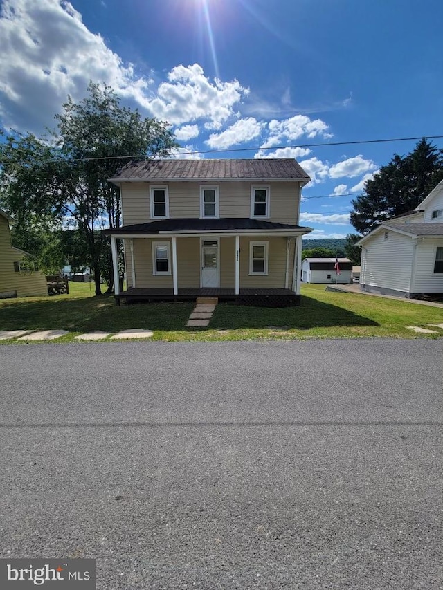 view of front of house featuring covered porch and a front lawn