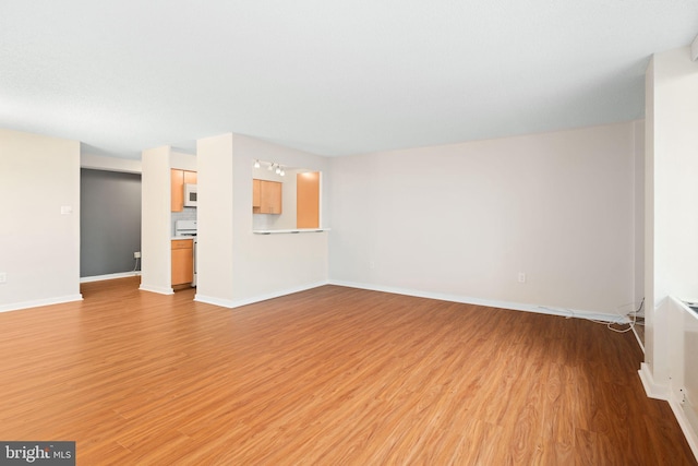 unfurnished living room with light hardwood / wood-style flooring