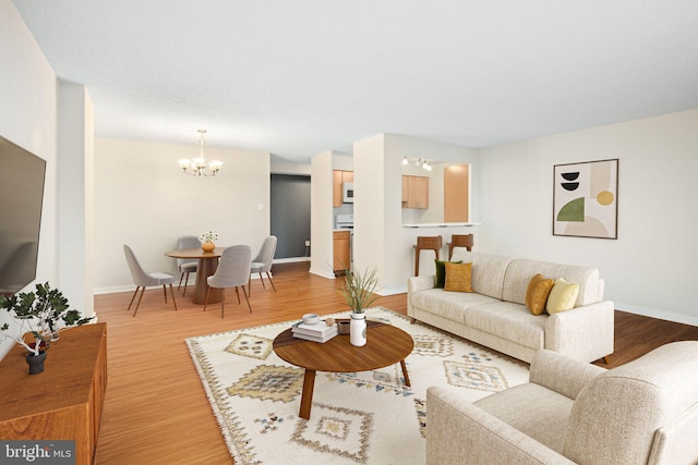 living room featuring hardwood / wood-style flooring and a notable chandelier