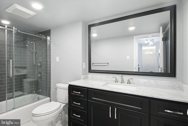 full bathroom featuring a chandelier, vanity, toilet, and enclosed tub / shower combo