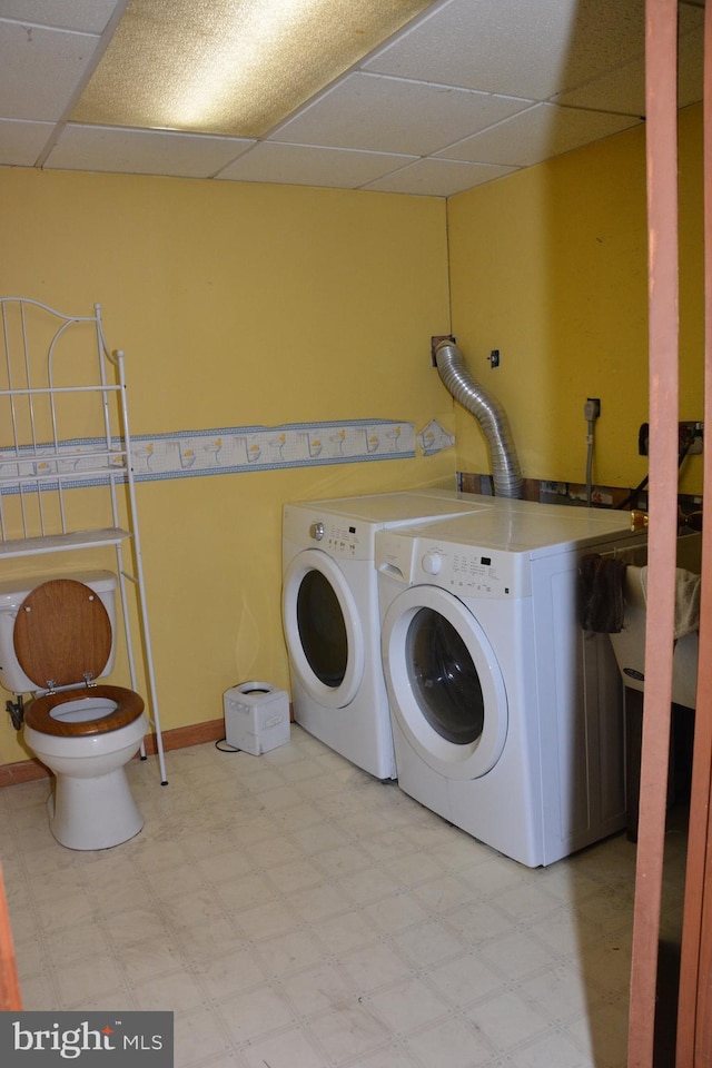 clothes washing area with washing machine and dryer