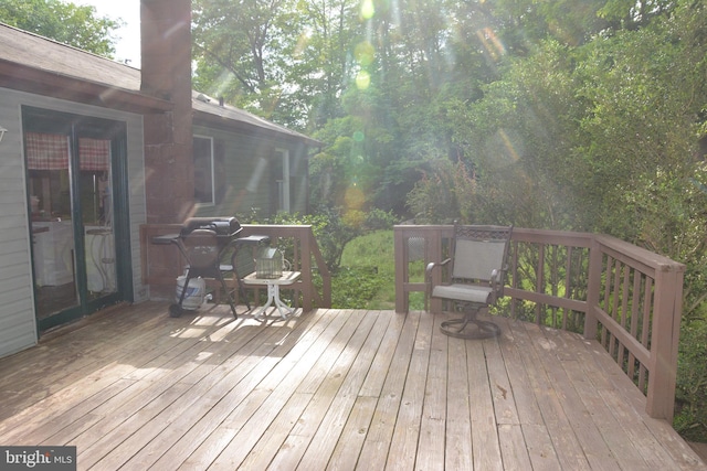 wooden deck featuring a grill