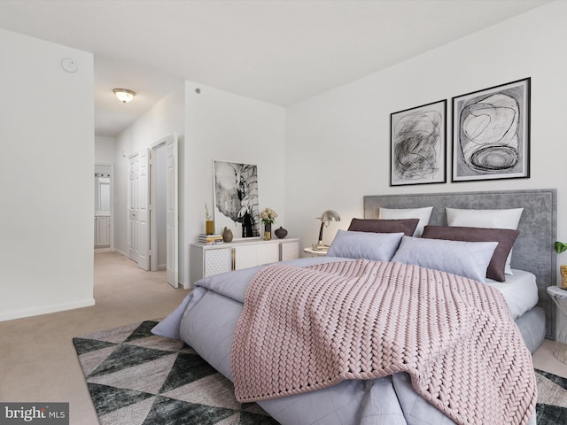 bedroom with light colored carpet