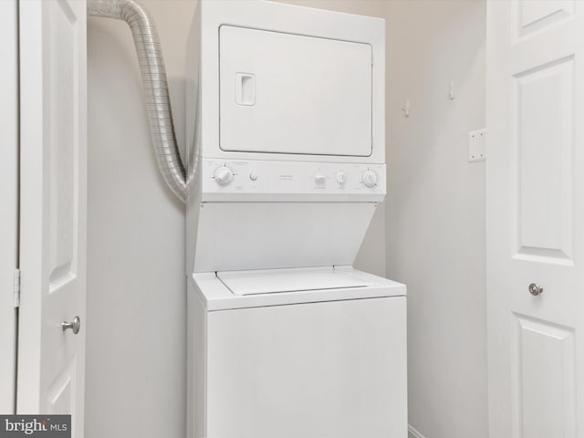 washroom featuring stacked washer and dryer