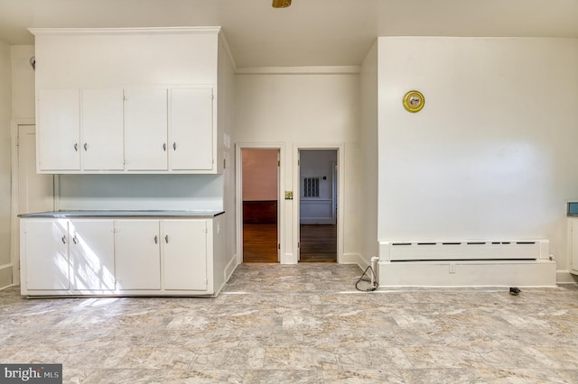 kitchen featuring white cabinetry, a baseboard heating unit, and light hardwood / wood-style floors