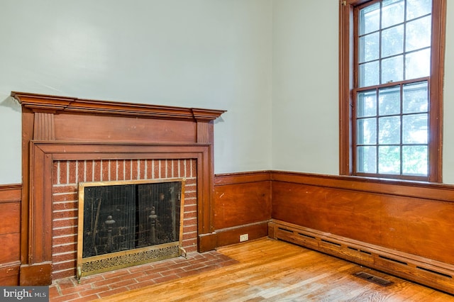 unfurnished living room featuring a fireplace and light wood-type flooring