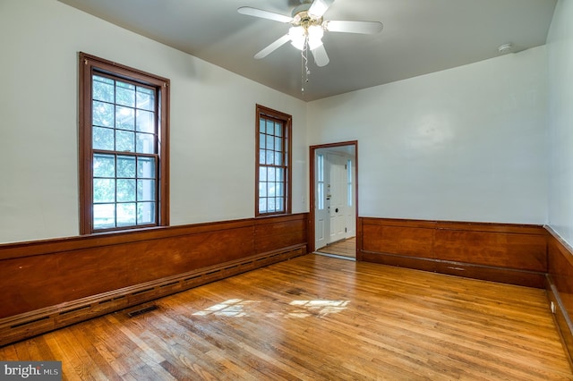 empty room with light hardwood / wood-style floors and ceiling fan