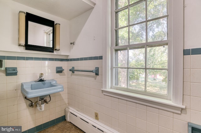 bathroom with plenty of natural light, tile walls, and tile patterned flooring