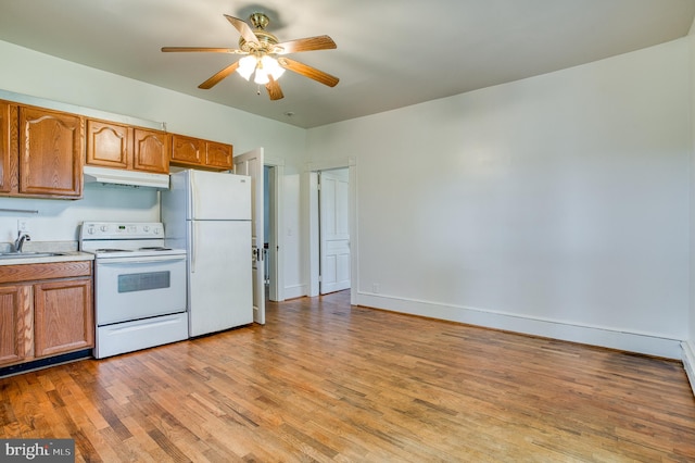 kitchen featuring ceiling fan, sink, light hardwood / wood-style flooring, and white appliances