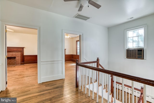 hall with wood-type flooring and cooling unit