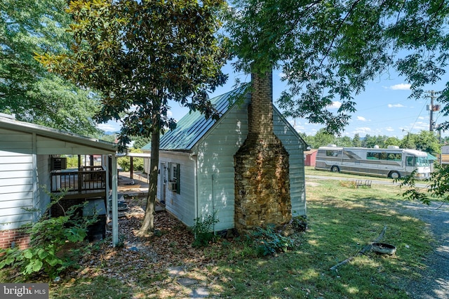 view of side of home with a deck and a yard