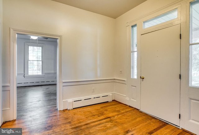 entrance foyer featuring hardwood / wood-style flooring and baseboard heating