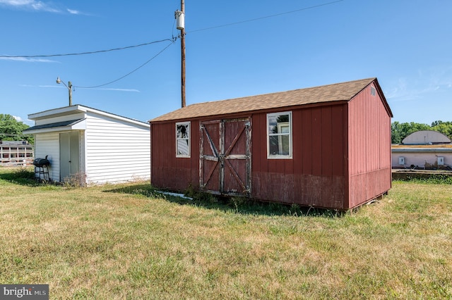 view of outbuilding with a yard