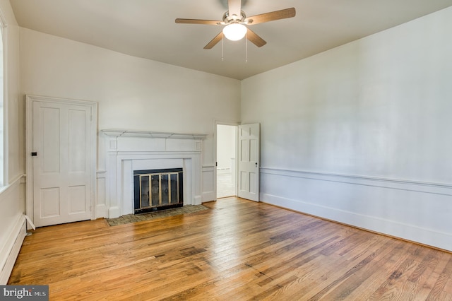 unfurnished living room featuring ceiling fan and light hardwood / wood-style flooring