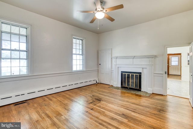 unfurnished living room with light hardwood / wood-style flooring, a baseboard radiator, and ceiling fan