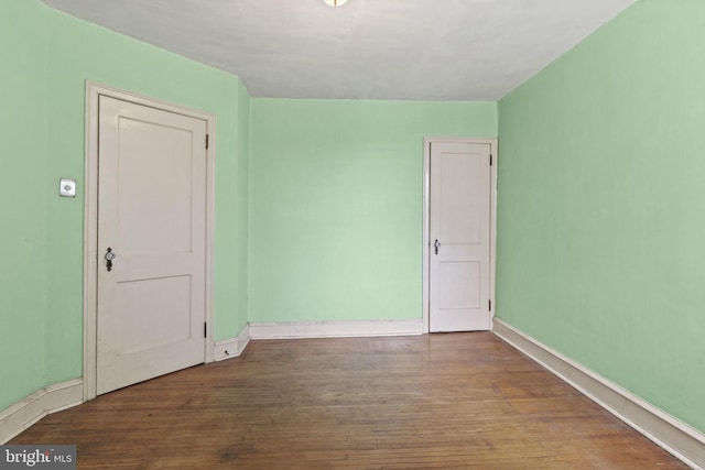 spare room with hardwood / wood-style flooring