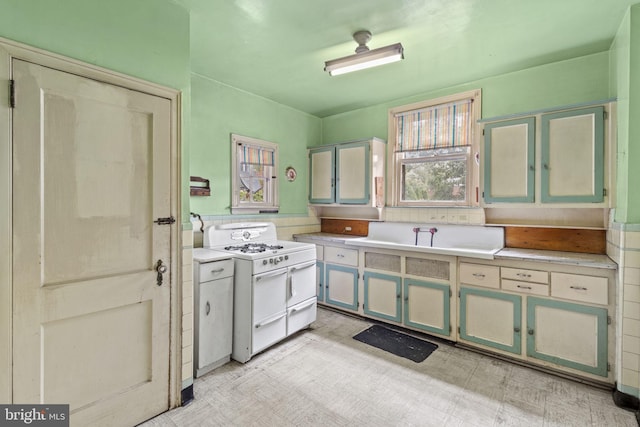 kitchen featuring sink and range with two ovens