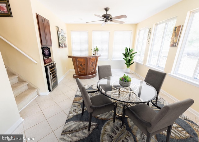 dining space with ceiling fan, beverage cooler, and light tile patterned flooring