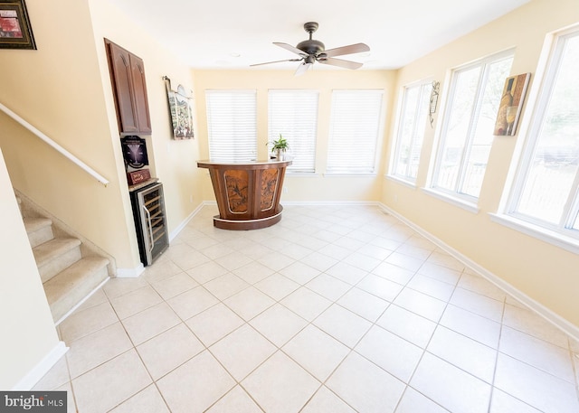 interior space with a wealth of natural light, wine cooler, and ceiling fan