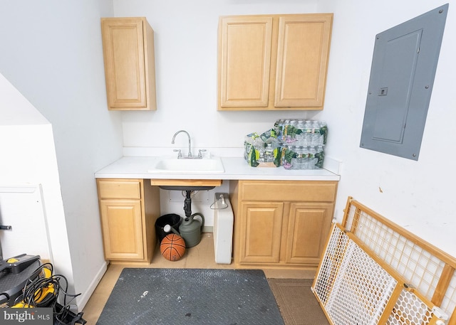 kitchen featuring electric panel, sink, and light brown cabinetry