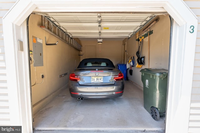 garage with electric panel and a garage door opener