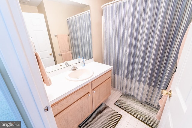 bathroom with tile patterned floors, curtained shower, and vanity