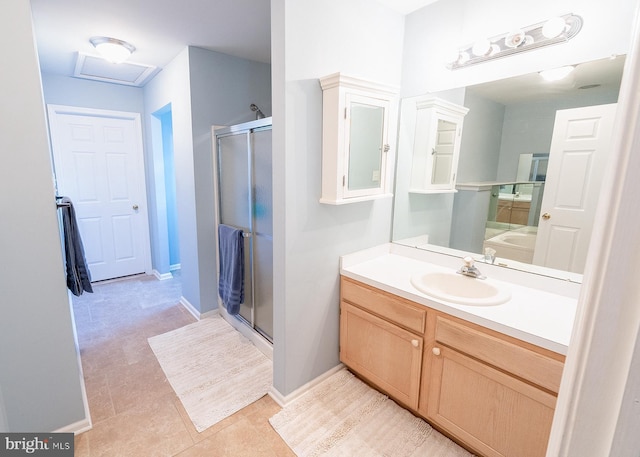 bathroom featuring plus walk in shower, vanity, and tile patterned floors