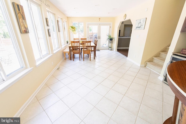 dining area featuring french doors and light tile patterned flooring