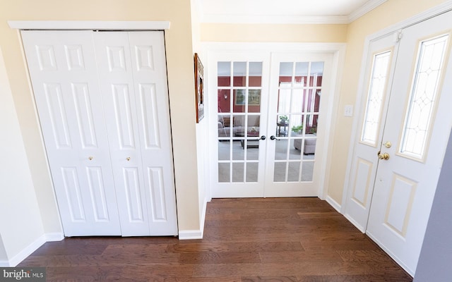 foyer entrance featuring french doors, dark hardwood / wood-style flooring, and ornamental molding