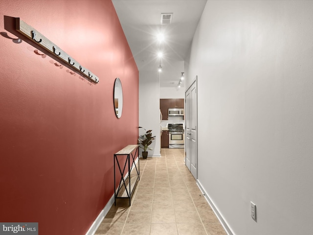 hallway featuring light tile patterned floors